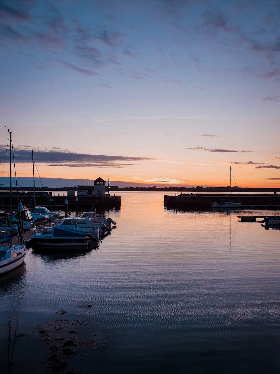 boats on dock during sunset